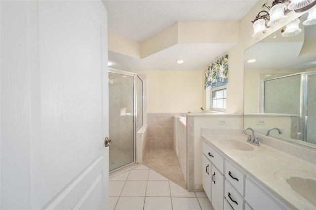 bathroom with tile patterned flooring, vanity, independent shower and bath, and a textured ceiling