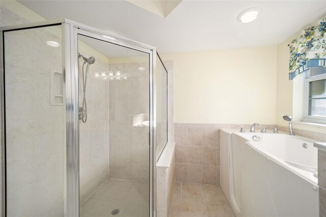5336 SW 109th Place Rd, Ocala, FL 34476 - full bath with a garden tub, a shower stall, tile patterned floors, and tile walls