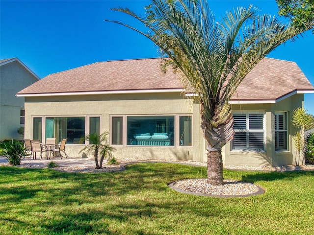 rear view of property featuring a yard and a patio