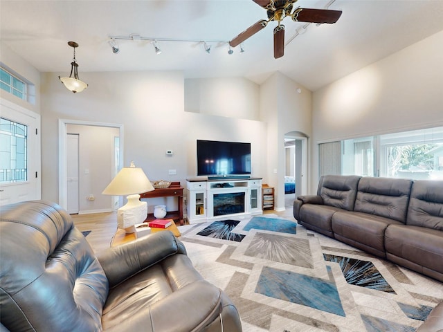 living room featuring ceiling fan, high vaulted ceiling, light hardwood / wood-style floors, and track lighting