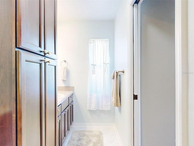 bathroom featuring tile patterned flooring and vanity