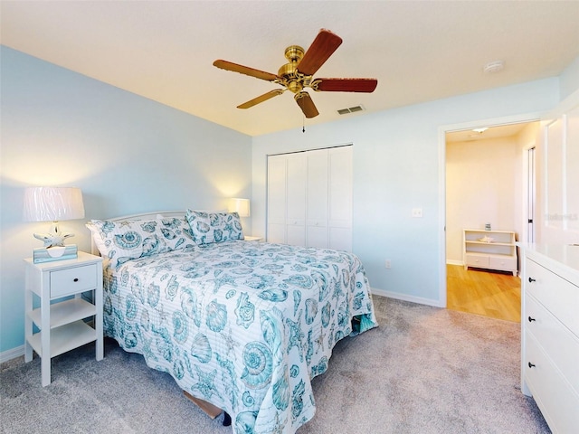 carpeted bedroom featuring ceiling fan and a closet