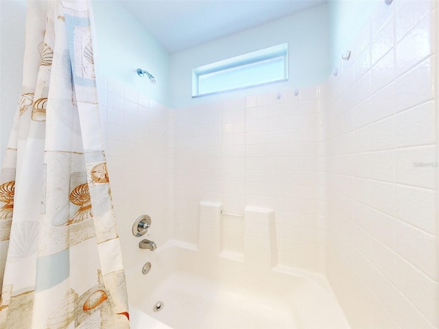 bathroom featuring shower / bathtub combination with curtain