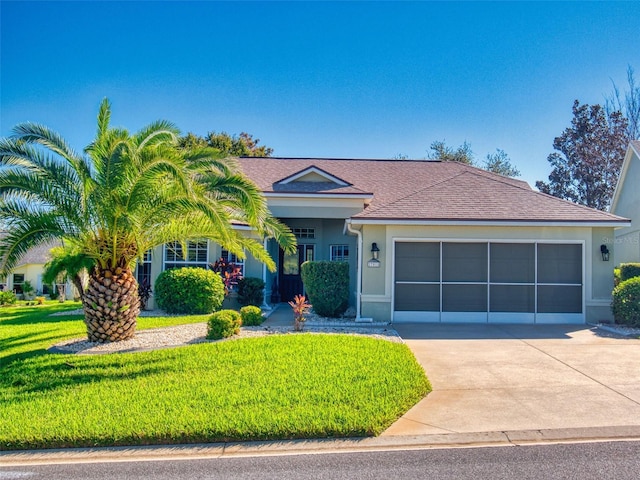 view of front of house with a garage and a front yard