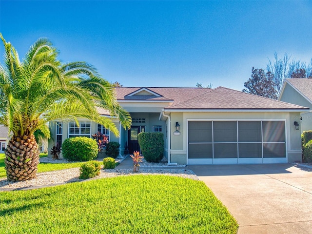 ranch-style home with a front yard and a garage