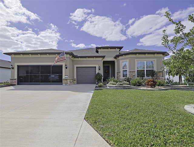 prairie-style home featuring a front yard and a garage