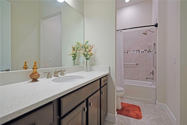 full bathroom with vanity, tiled shower / bath combo, and toilet