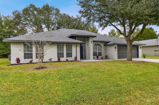 view of front of property with a garage and a front lawn