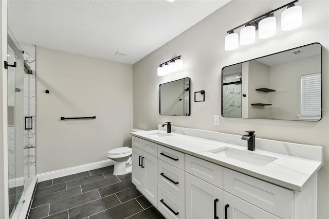 bathroom featuring tile patterned floors, a shower with door, vanity, and a textured ceiling