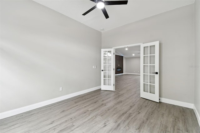 spare room featuring ceiling fan, french doors, and light hardwood / wood-style floors