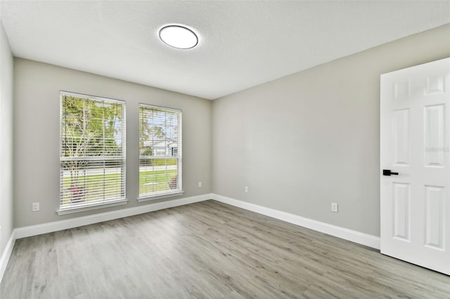 empty room featuring hardwood / wood-style floors and a textured ceiling