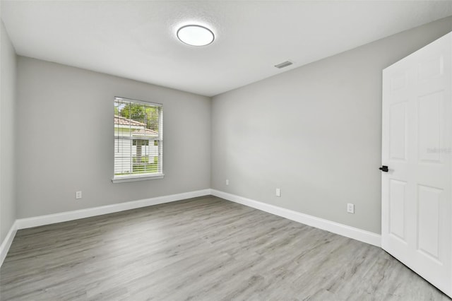 empty room with light hardwood / wood-style floors