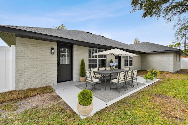 rear view of property with a lawn