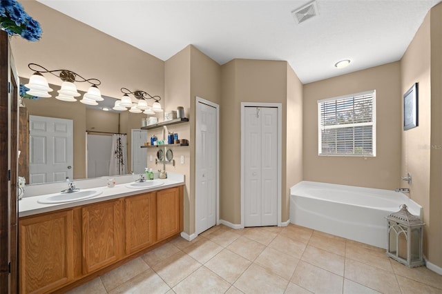 bathroom featuring vanity, tile patterned floors, and separate shower and tub