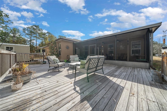 wooden deck with a sunroom and an outdoor hangout area