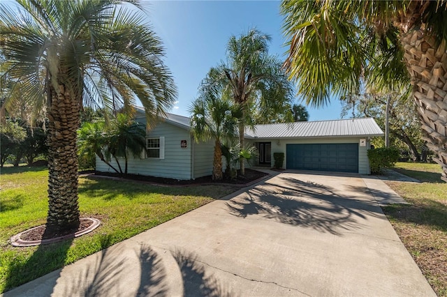 view of front of property with a garage and a front lawn