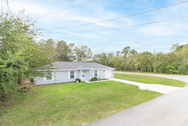 ranch-style house with a garage and a front lawn