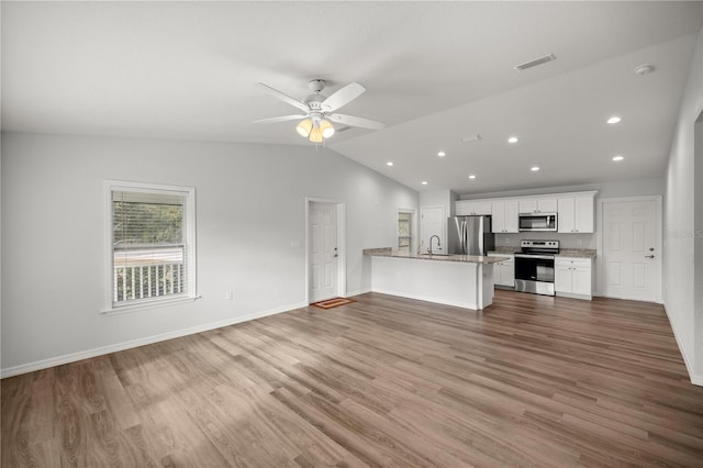 unfurnished living room featuring hardwood / wood-style floors, ceiling fan, lofted ceiling, and sink