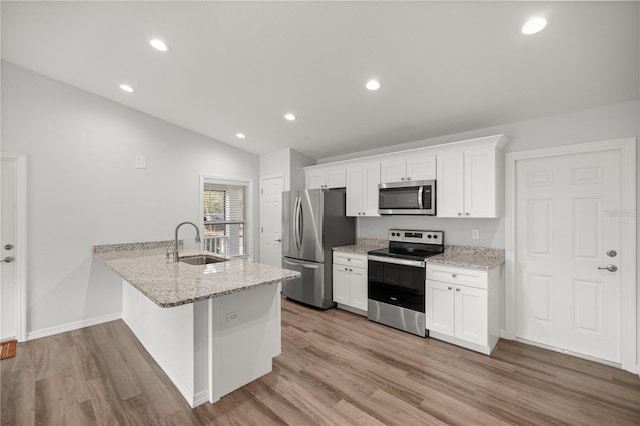 kitchen with white cabinetry, sink, stainless steel appliances, and lofted ceiling