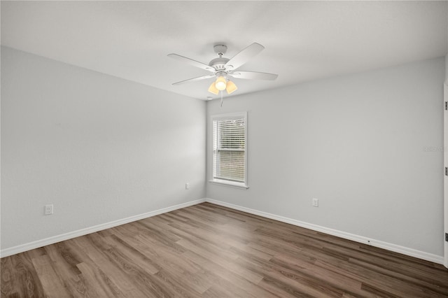 spare room featuring wood-type flooring and ceiling fan