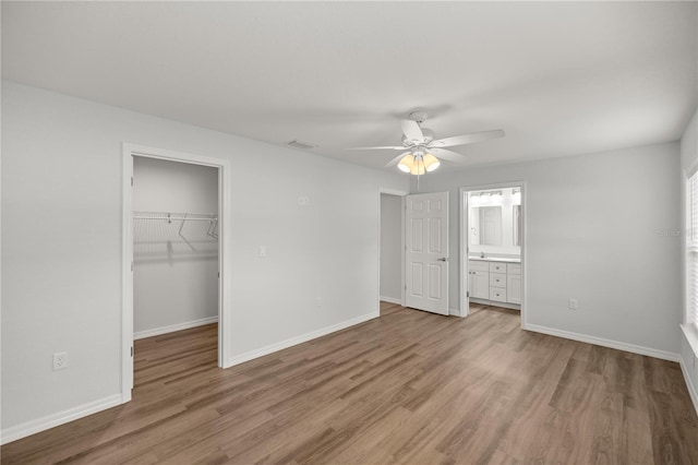 30 Maple Crse, Ocklawaha, FL 32179 - unfurnished bedroom with light wood-style flooring, baseboards, and a walk in closet