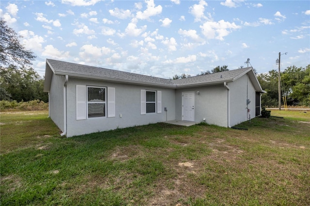 back of house featuring a yard