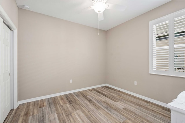 unfurnished bedroom with ceiling fan, a closet, and light hardwood / wood-style flooring