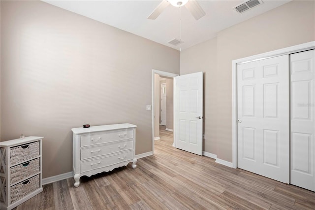 bedroom with light wood-type flooring, a closet, and ceiling fan