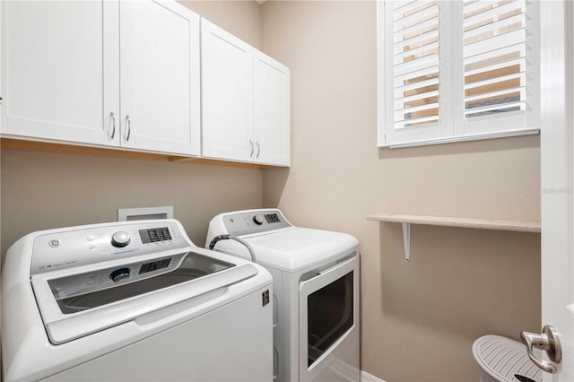 laundry room with cabinets and washing machine and dryer