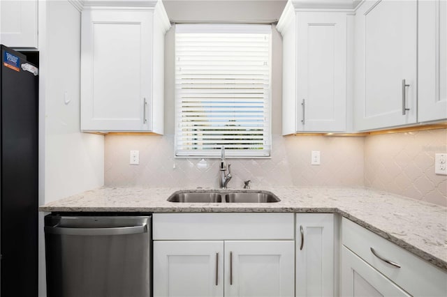 kitchen featuring stainless steel dishwasher, white cabinetry, and sink