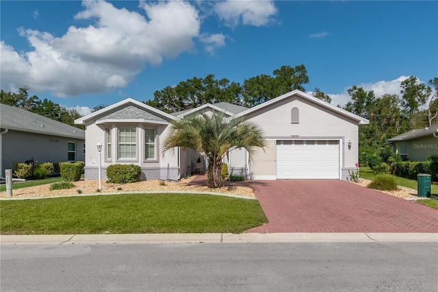 single story home with a front yard and a garage