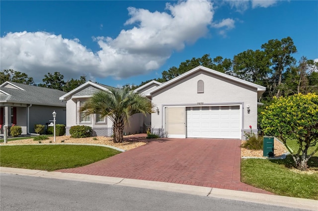 ranch-style house featuring a garage and a front yard