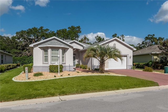 ranch-style house featuring a garage and a front lawn