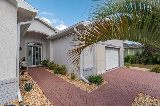 doorway to property with a garage