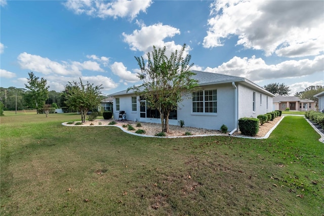 rear view of property with a lawn