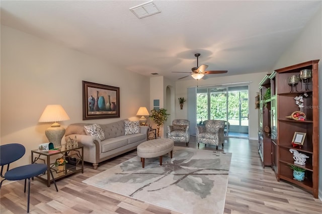 living room featuring light wood-type flooring and ceiling fan