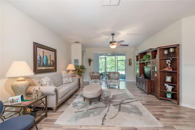 living room featuring ceiling fan and light hardwood / wood-style flooring