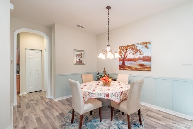 dining room featuring a chandelier and light hardwood / wood-style flooring