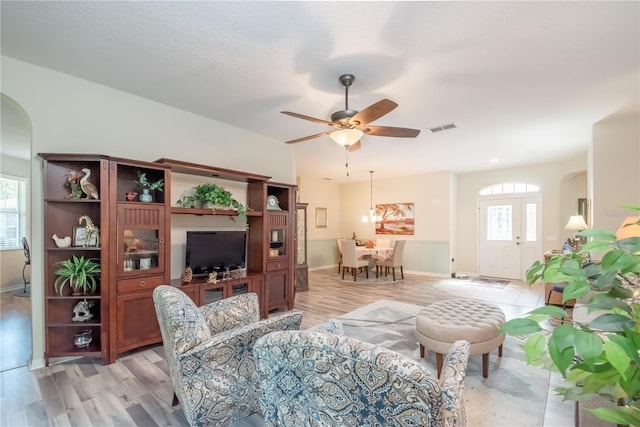 living room with ceiling fan, a healthy amount of sunlight, and light wood-type flooring