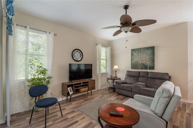 living room with hardwood / wood-style flooring and ceiling fan