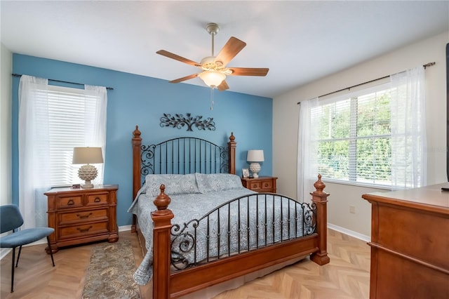 bedroom with ceiling fan and light parquet floors