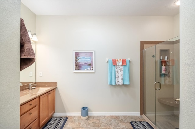 bathroom featuring vanity and an enclosed shower