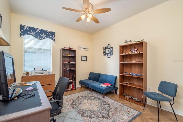 office space with ceiling fan and light parquet floors