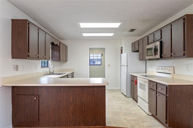 kitchen with kitchen peninsula, dark brown cabinets, white electric stove, and sink