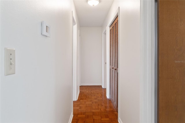 hall featuring dark parquet flooring