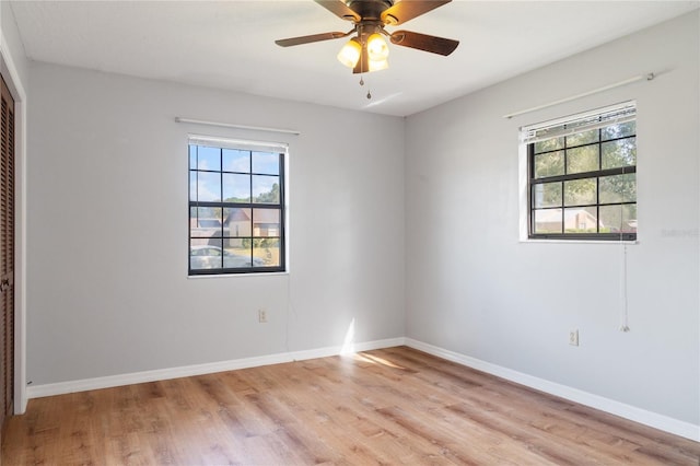 unfurnished room featuring light hardwood / wood-style flooring, a wealth of natural light, and ceiling fan