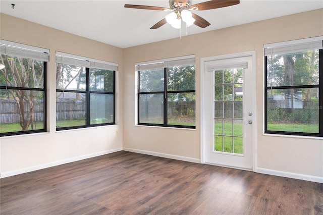 unfurnished sunroom featuring plenty of natural light and ceiling fan