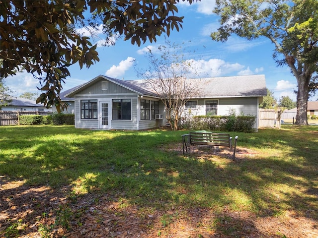 back of house featuring a yard