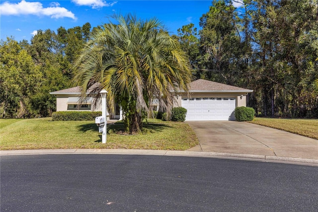 view of front of home with a front yard and a garage