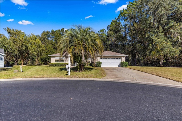 view of property hidden behind natural elements featuring a garage and a front lawn